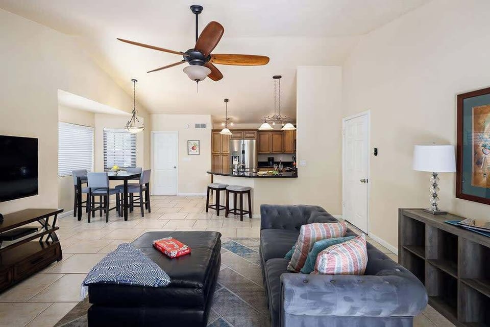 Main living area with designer furnishings, smart TV, and a fireplace.