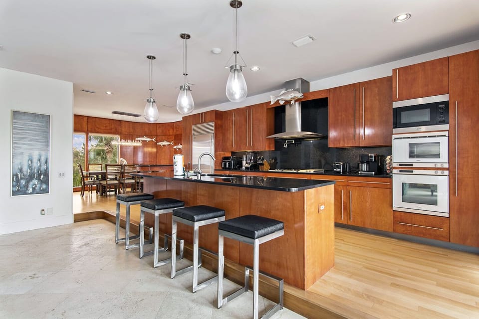 Modern kitchen w/ wood cabinetry, island seating & plenty of prep space