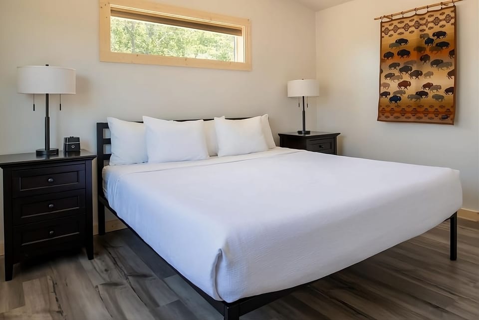 Unwind into crisp linens beneath soft light and calm views.