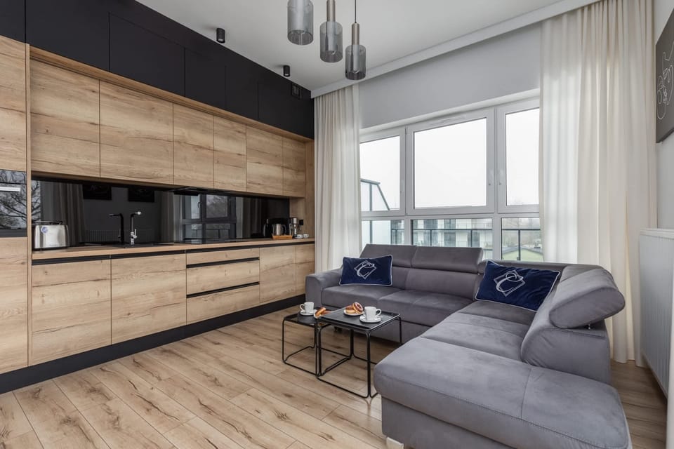 A wooden-finished kitchen with sleek cabinetry, modern appliances, and an open layout.