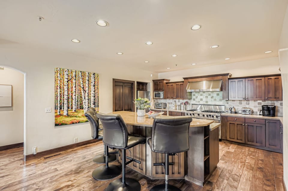 Your spacious kitchen features premium appliances, granite countertops, and a welcoming island with bar seating - perfect for cooking memorable meals together.