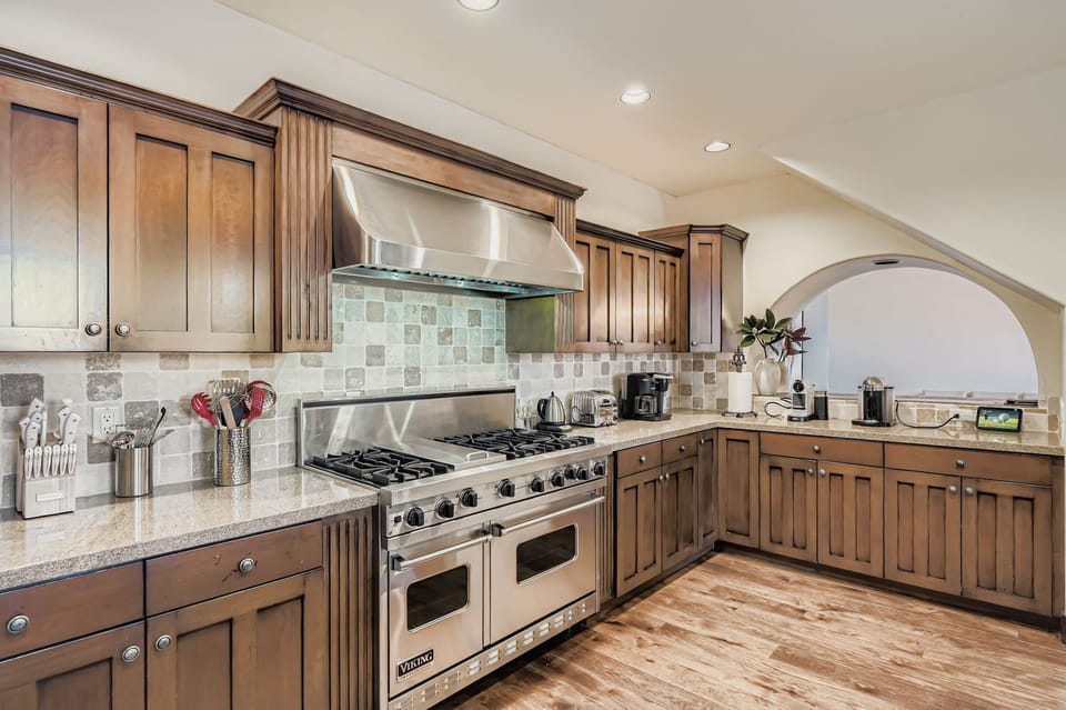 Your gourmet kitchen features rich wood cabinetry, granite countertops, and professional-grade stainless steel appliances for all your culinary adventures.