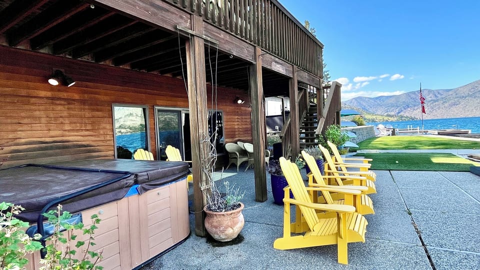 Downstairs patio with hot tub and lakeside seating