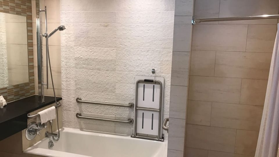 Enjoy an accessible bath setup with supportive rails for comfort