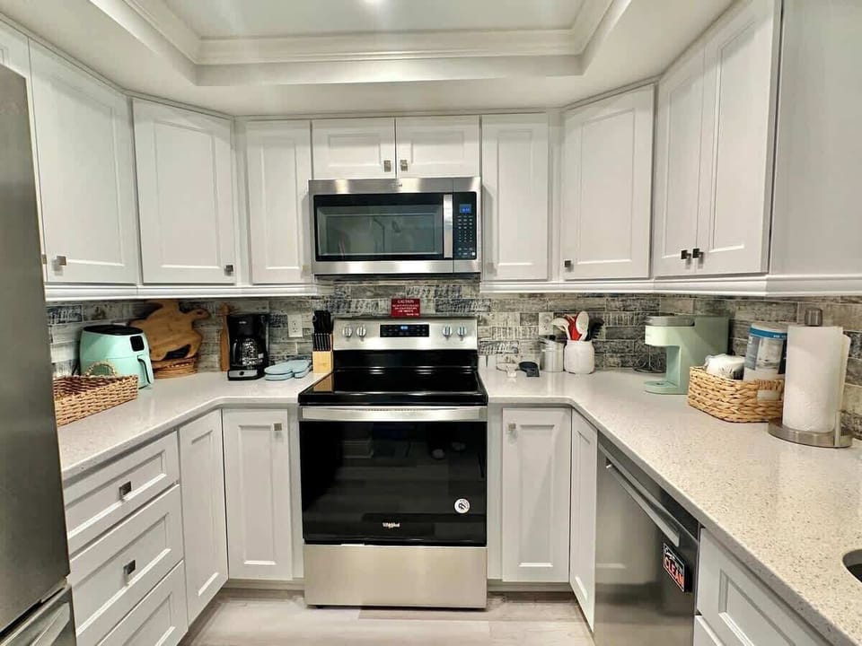 Modern kitchen with stainless steel appliances and white cabinetry