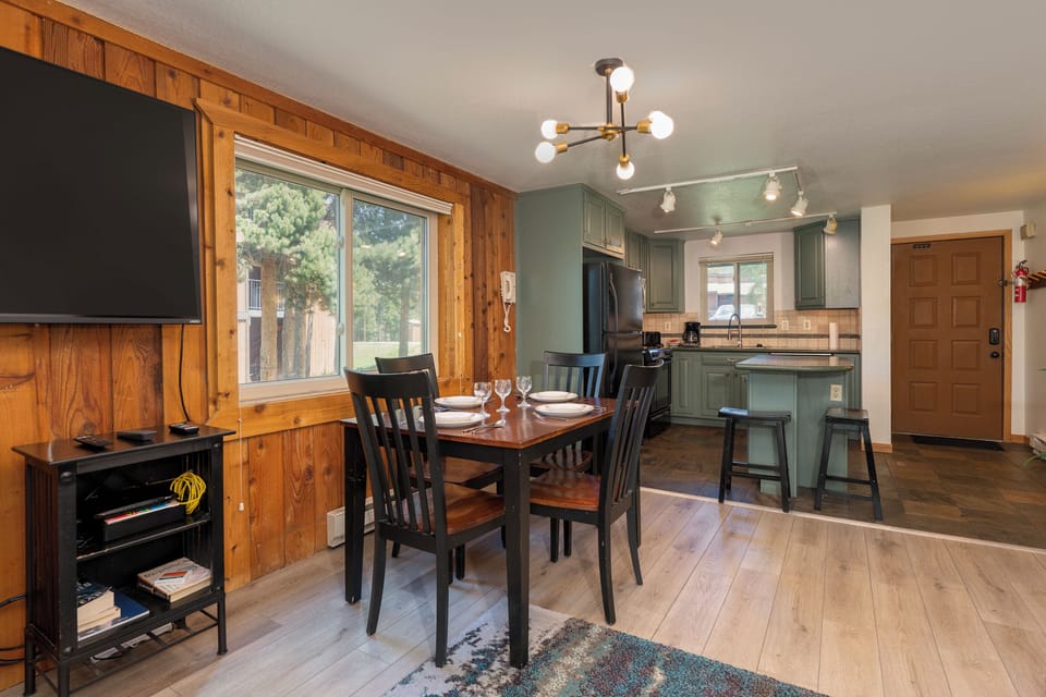 Gather around your charming dining table for home-cooked meals in this thoughtfully designed open-concept space with warm wood accents.