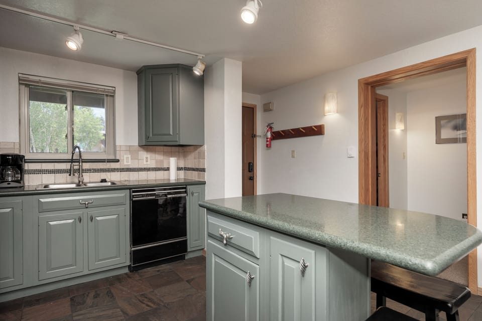 Your spacious kitchen features sage cabinets, granite counters, and everything needed to create memorable meals during your stay.