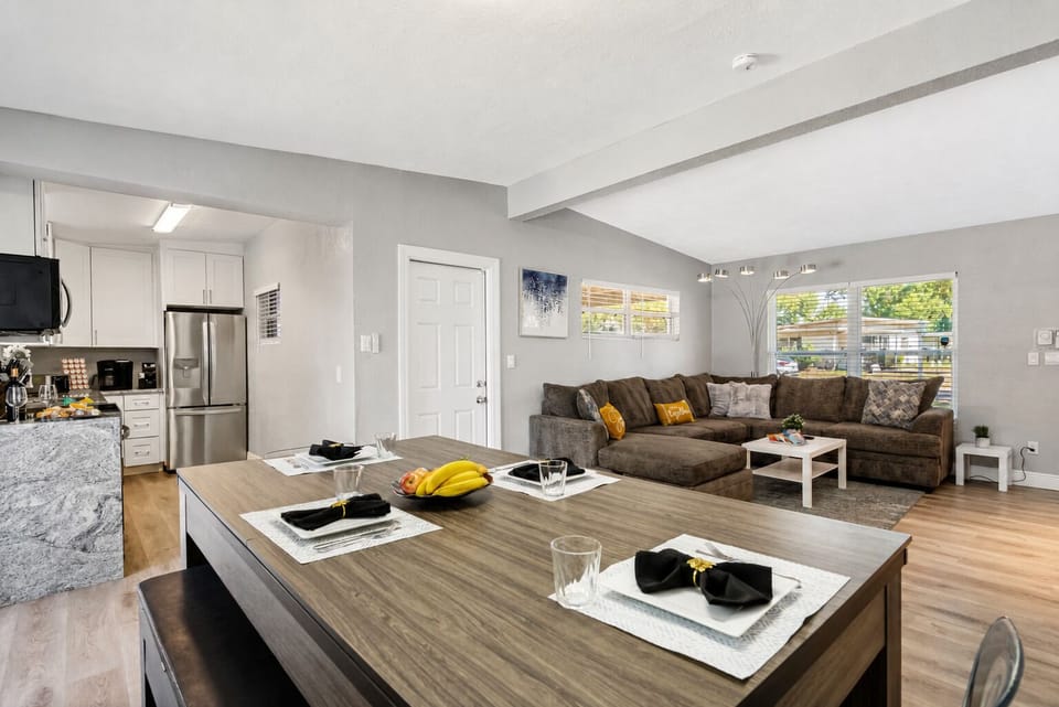 The table's sleek design features a high-quality wood finish that blends seamlessly into any modern interior decor. 