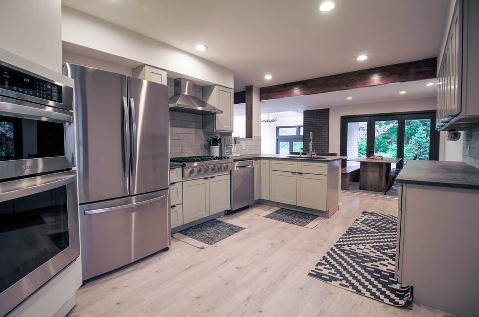 Chef's kitchen: Newly renovated open concept with dual ovens and 6-burner stove.