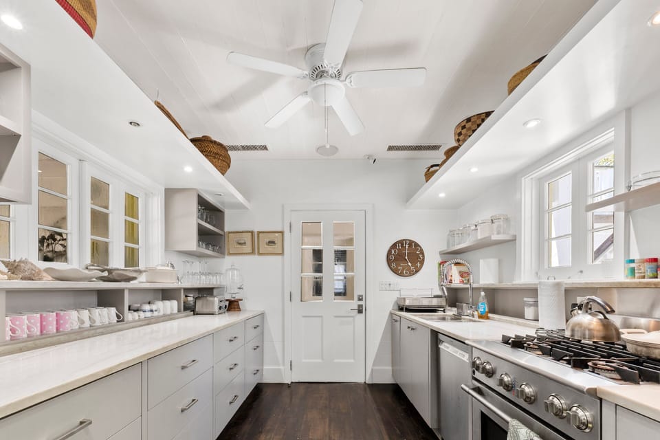 Fully equipped with top-of-the-line Elextrolux Icon appliances including a built-in column refrigerator-freezer, gas range, dishwasher, and many small appliances.