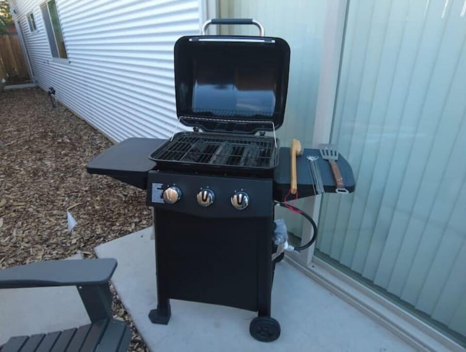 A small gas grill and a few accessories.