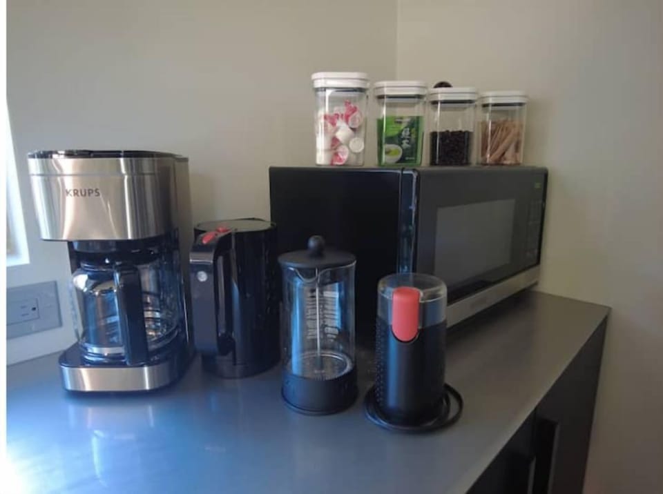 Enjoy coffee, grinder, filters, drip, French press, green tea, cream, and sugar.