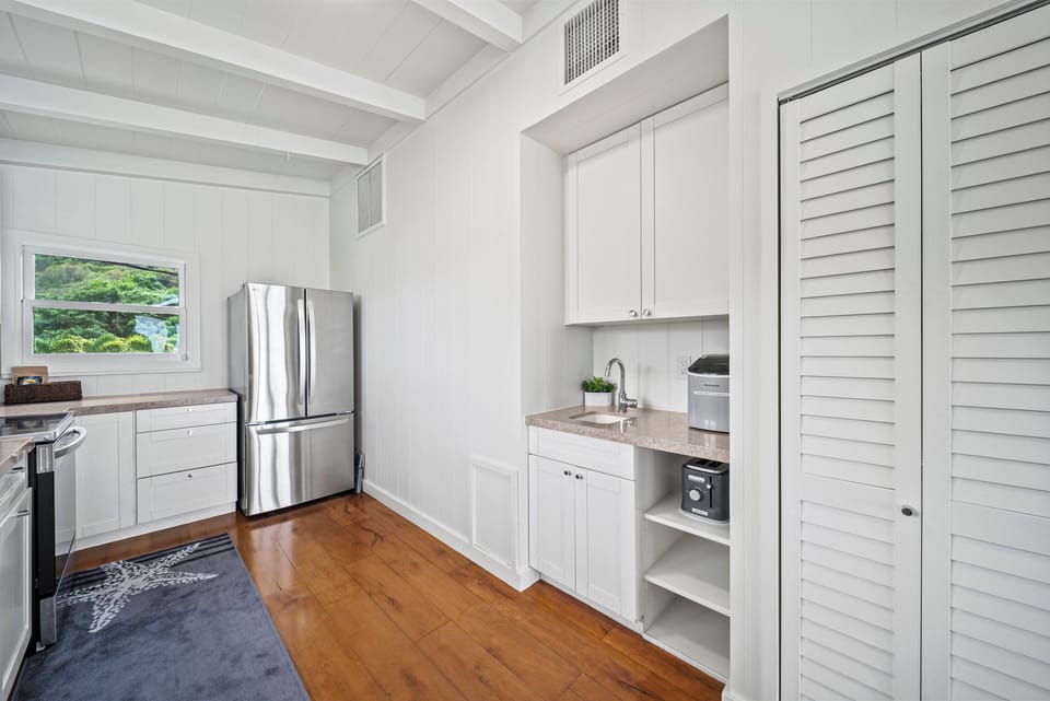 Additional kitchen angle showcasing upgraded appliances and organized storage for a seamless vacation cooking experience.