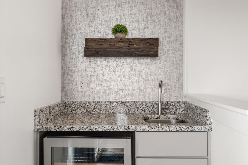 The wet bar on the third level — a mini fridge, and a sink.