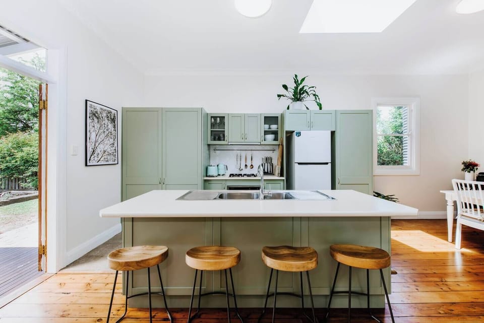 A gorgeous country kitchen is designed around a central island bench with a breakfast bar.

