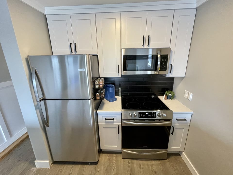 Kitchen is stocked with all necessities, a Keurig, and an assortment of spices.