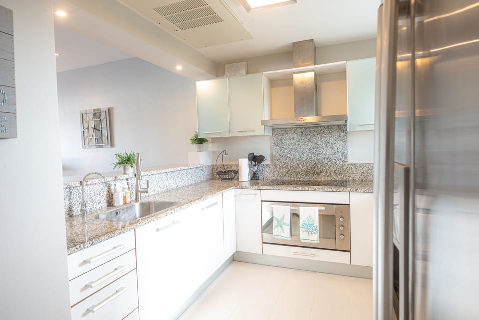 Kitchen with pass through to dining area and breakfast bar.