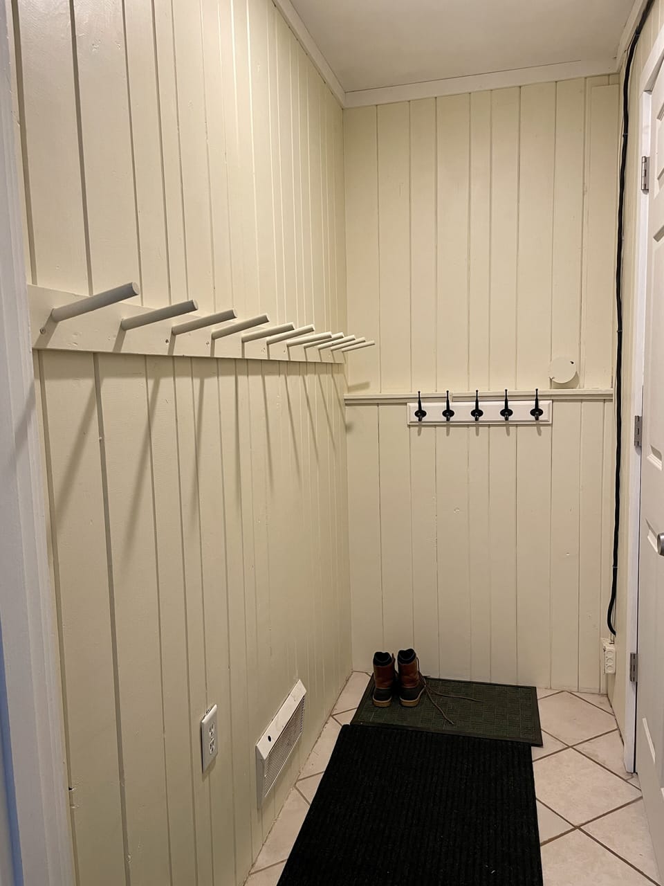 Ski coat and boots hallway next to laundry room