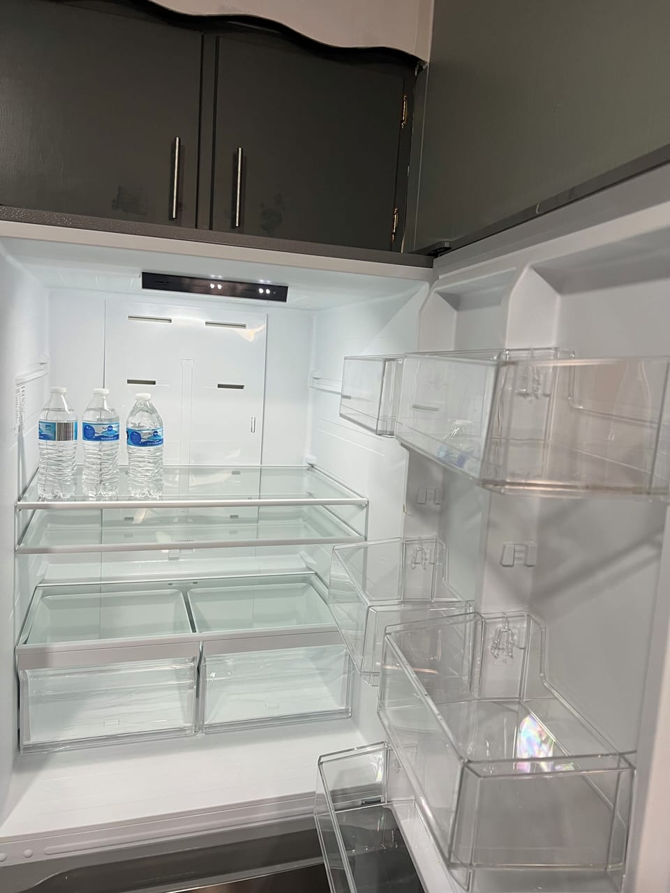 Refrigerator stocked with limited water bottles