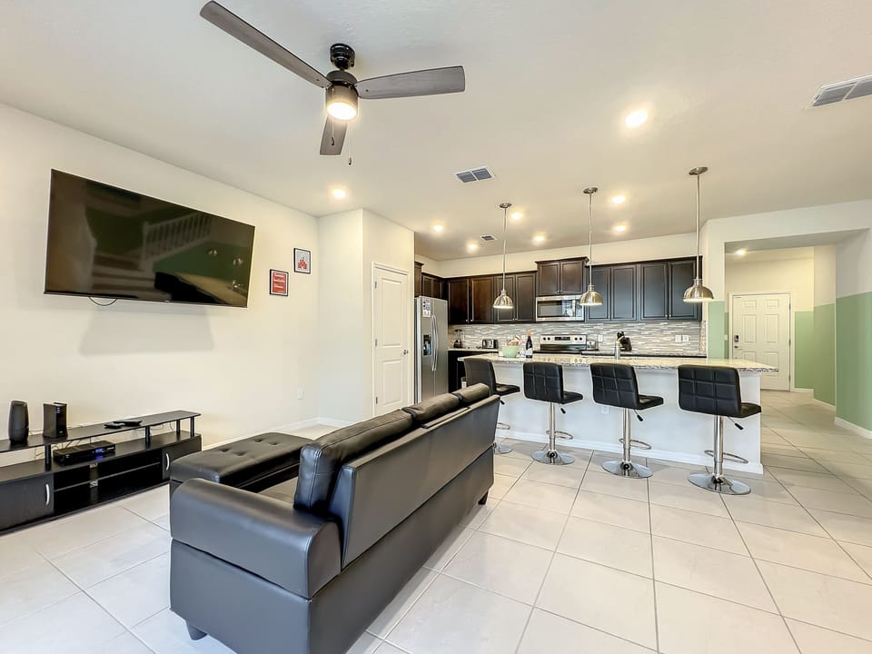 Effortlessly entertain with this open living, dining, and kitchen area.