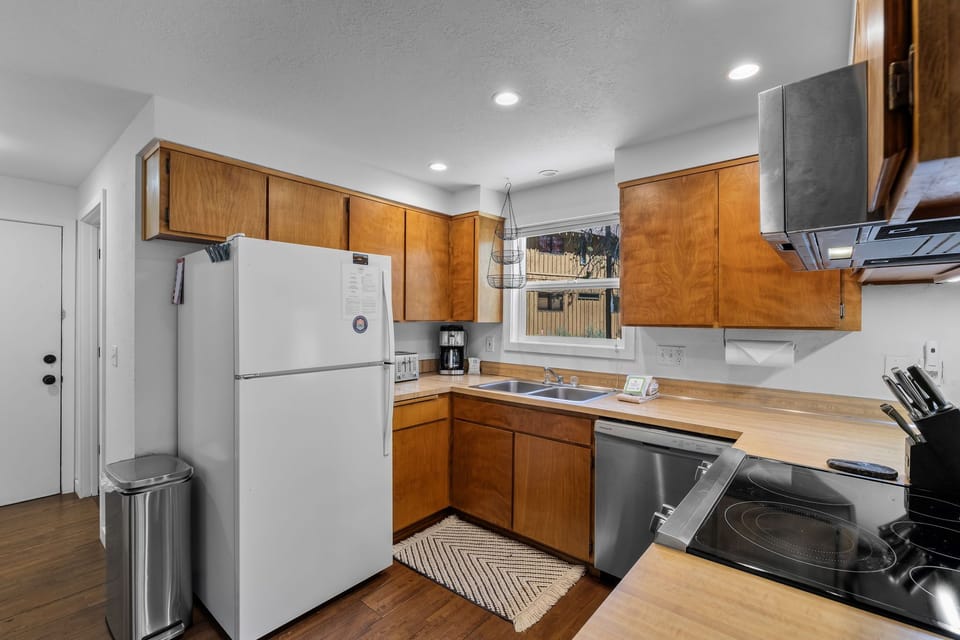 Your fully equipped kitchen with warm wood cabinetry, modern appliances, and everything you need to prepare delicious home-cooked meals during your stay.