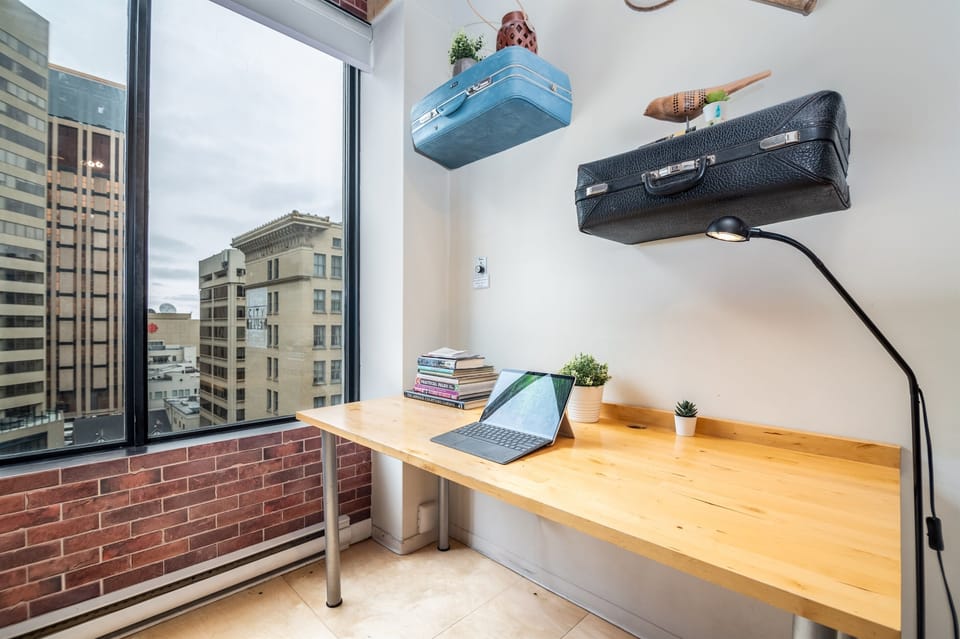 Stylish work station with vintage-inspired decor and ample natural light for productivity in a creative space