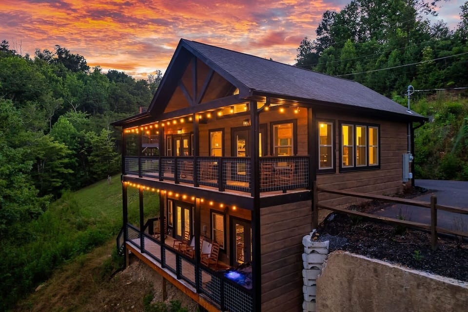 Ridgeview Retreat's expansive upper and lower decks light up for evenings with sweeping Smoky Mountain views