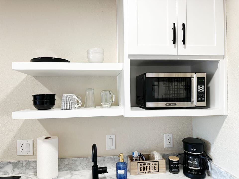 Microwave, coffee pot, spices, toaster, hot water kettle, griddle, pots, pans, 