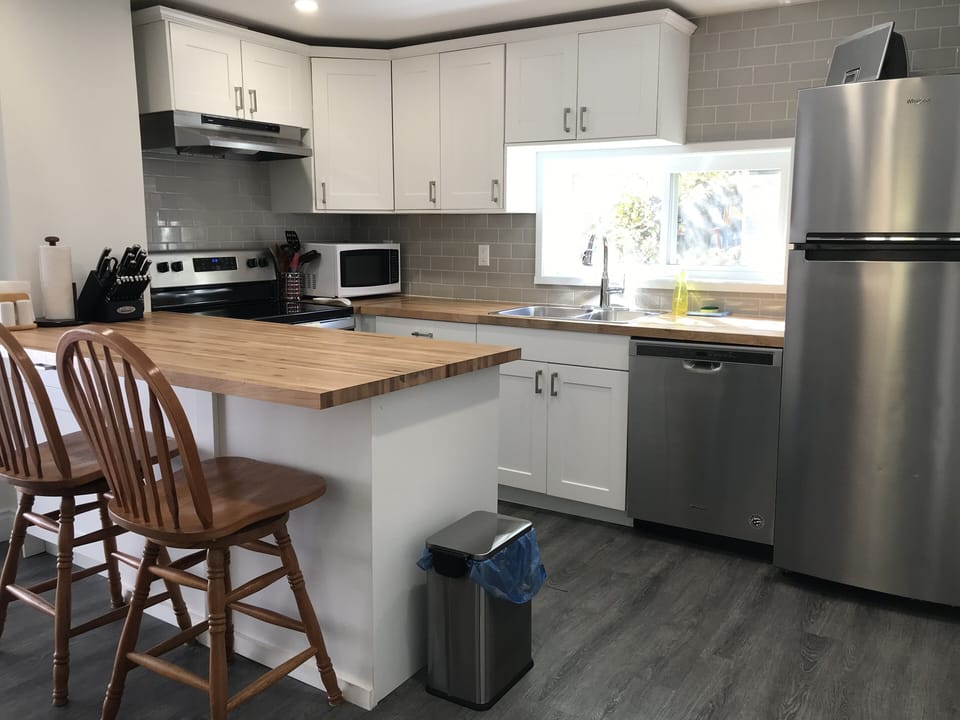 Kitchen - Stove top oven, Microwave, Dishwasher, Refrigerator.