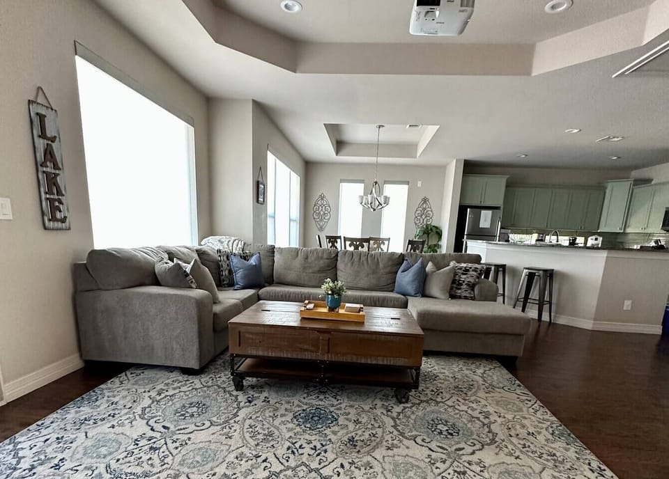 Upstairs living room, get cozy on this sectional and enjoy the projector screen.