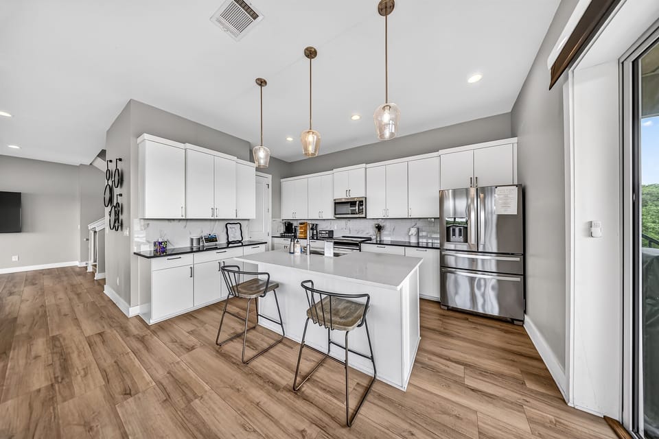 - Modern kitchen with stainless appliances offers bright lakeview charm - Island seating supports cooking chatting and fun vacation moments - Clean layout elevates your lakeside experience with style and ease