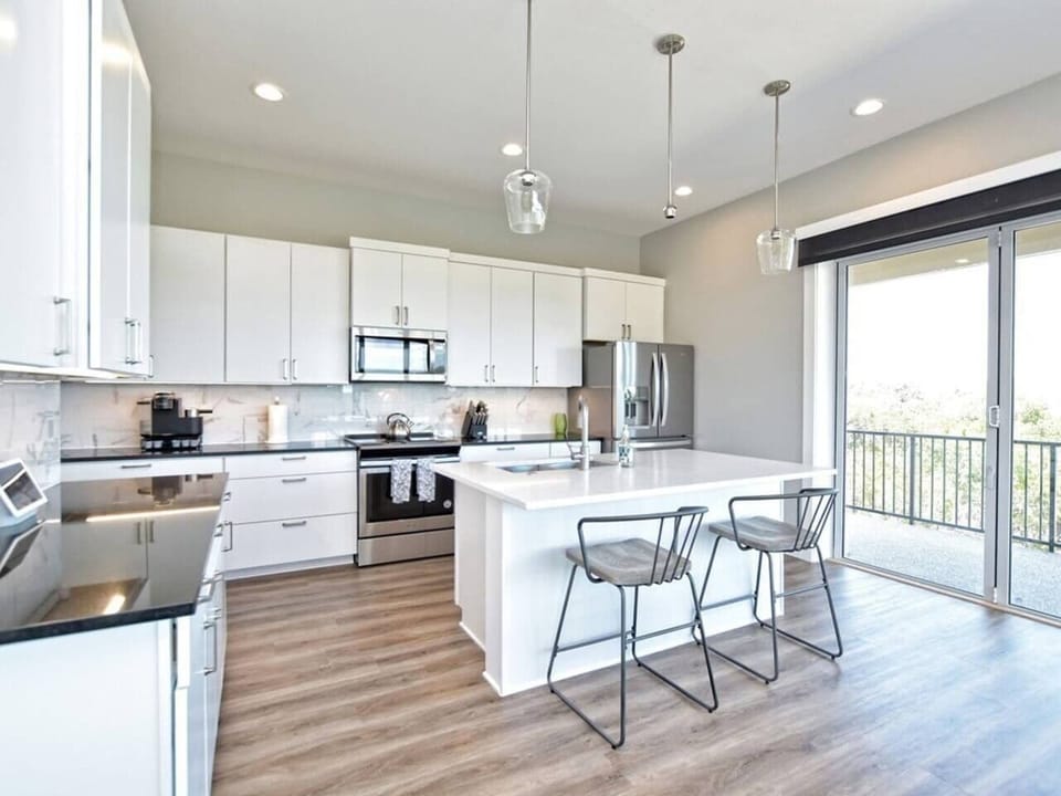 - Modern kitchen with stainless appliances offers bright lakeview charm - Island seating supports cooking chatting and fun vacation moments - Clean layout elevates your lakeside experience with style and ease