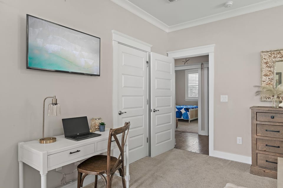 Cozy home office nook with calming coastal artwork