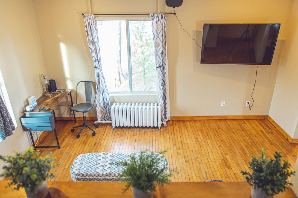 The steps to the upstairs oversee the living area with desk