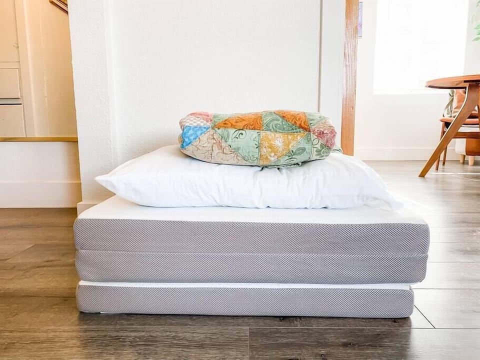 Tri folding mattress and extra bedding for an extra guest. 