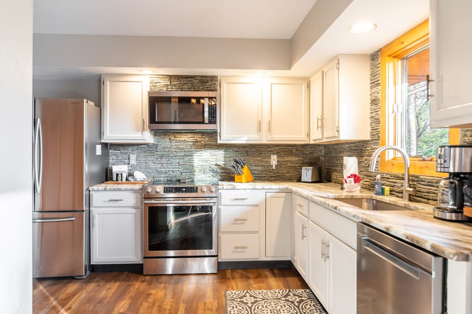 Enjoy cooking in the fully-equipped kitchen with stainless appliances.
