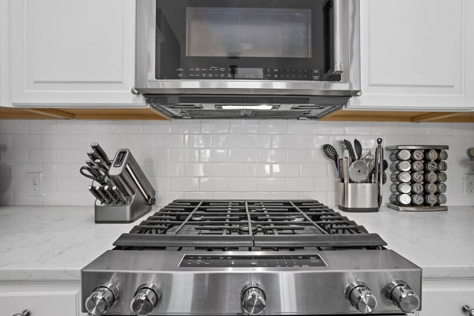 Cook with confidence—fully equipped Cedar Park kitchen with gas range, sharp knives, and essentials for easy meals on short or long stays.