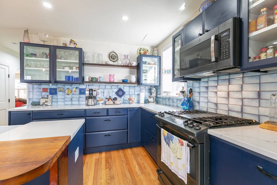 The high-end stainless steel kitchen appliances include a gas stovetop, oven and microwave.