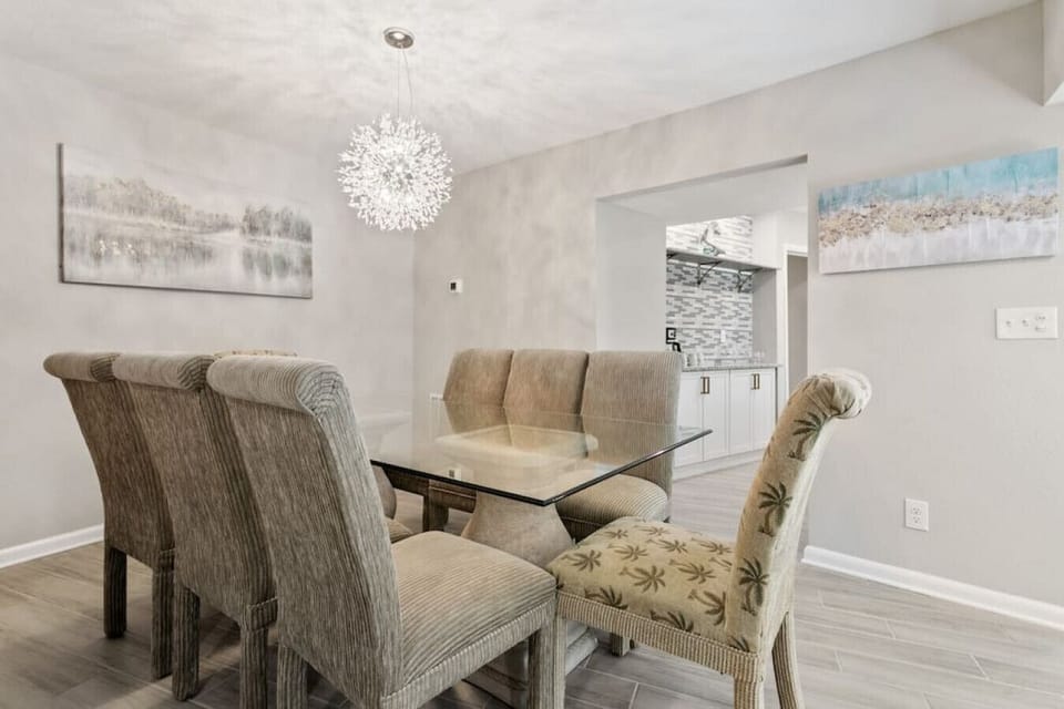 Dining room with large dining room table overlooking the pool deck.