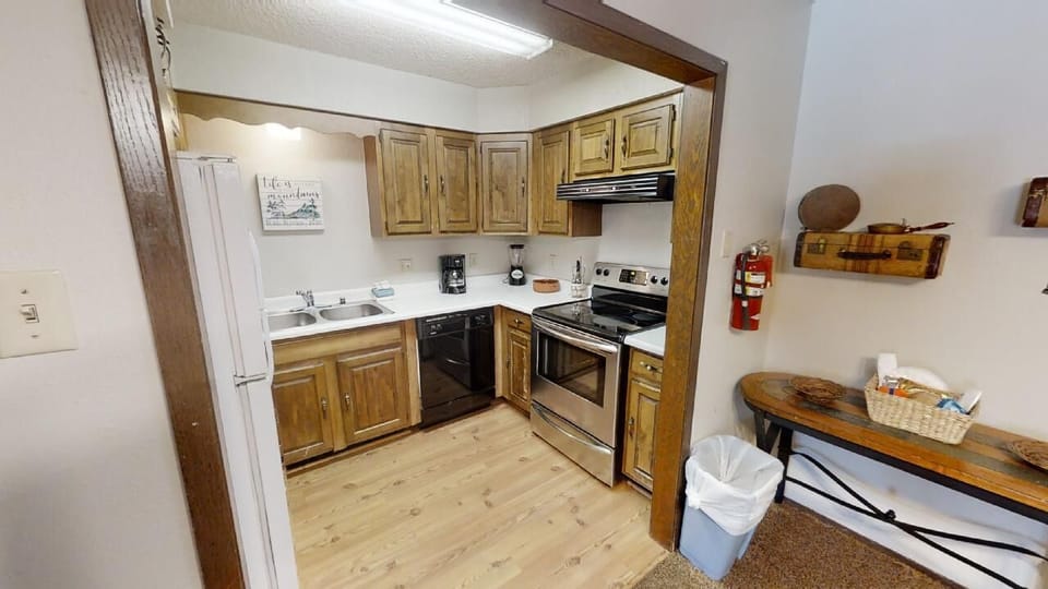 Your fully equipped kitchen features warm wood cabinetry, modern appliances, and all the essentials for preparing home-cooked meals during your mountain getaway.