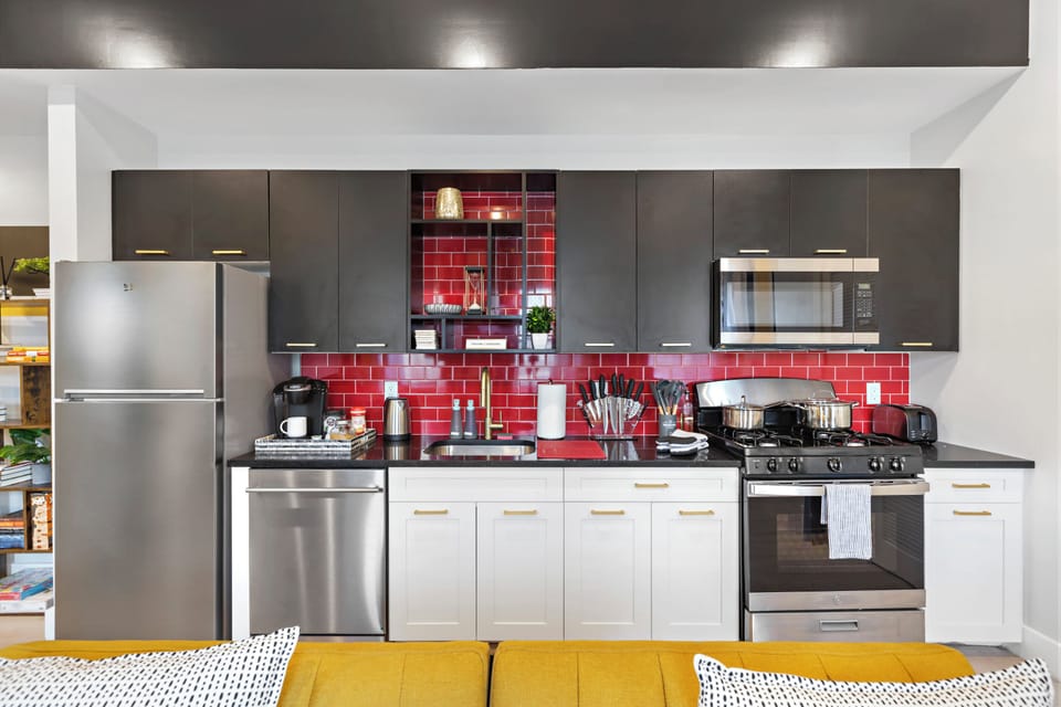 Fully-equipped kitchen with modern stainless steel appliances, ample countertop space, and a wide range of cookware, ensuring a seamless cooking experience for all your culinary needs.
