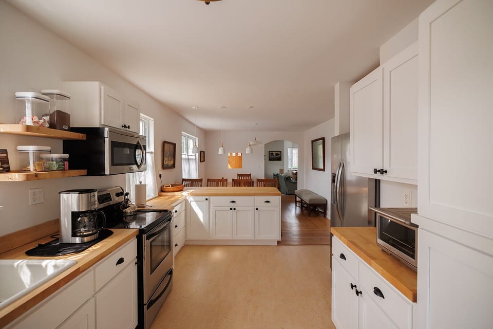 Fully stocked kitchen with dishwasher, microwave, oven, toaster, coffee pot, Keurig, and more. 