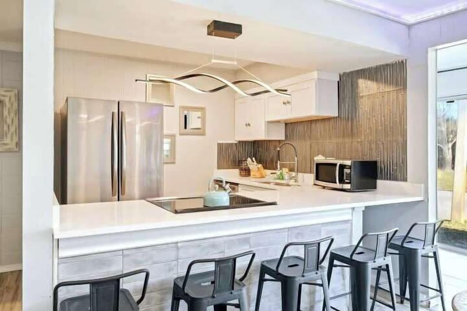 You'll love having a breakfast bar with plenty of barstools to enjoy meals together.