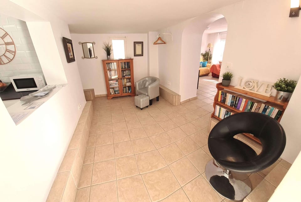 Library, leading to utility room with built-in safe, washing machine, iron etc