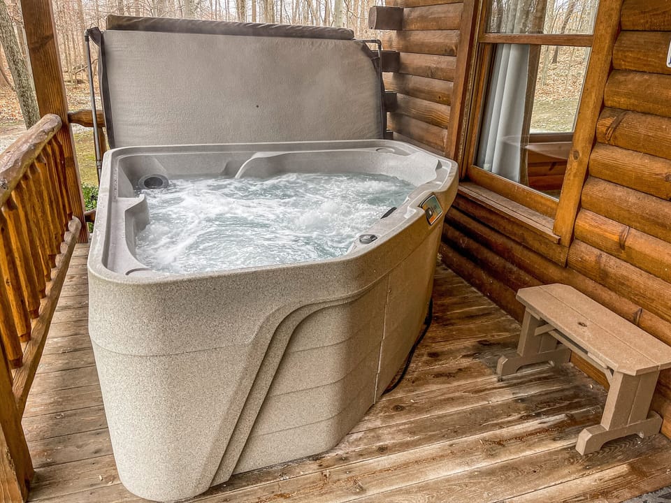 Two person hot tub on front porch.