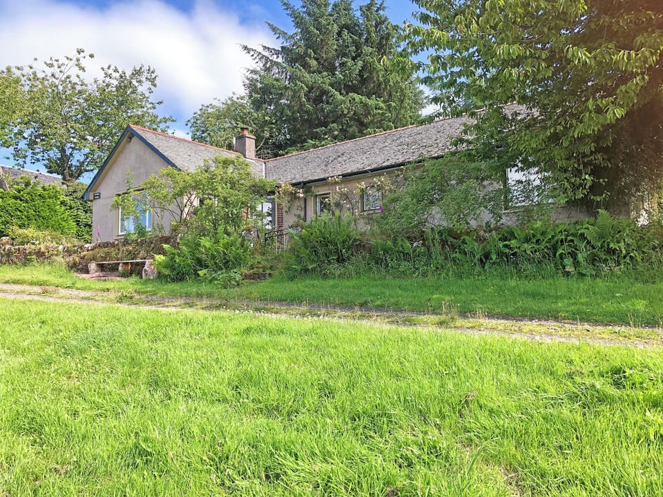 Decking with picnic table, french doors out from dining/living area | Garrique Cottage, By Kippen, near Stirling