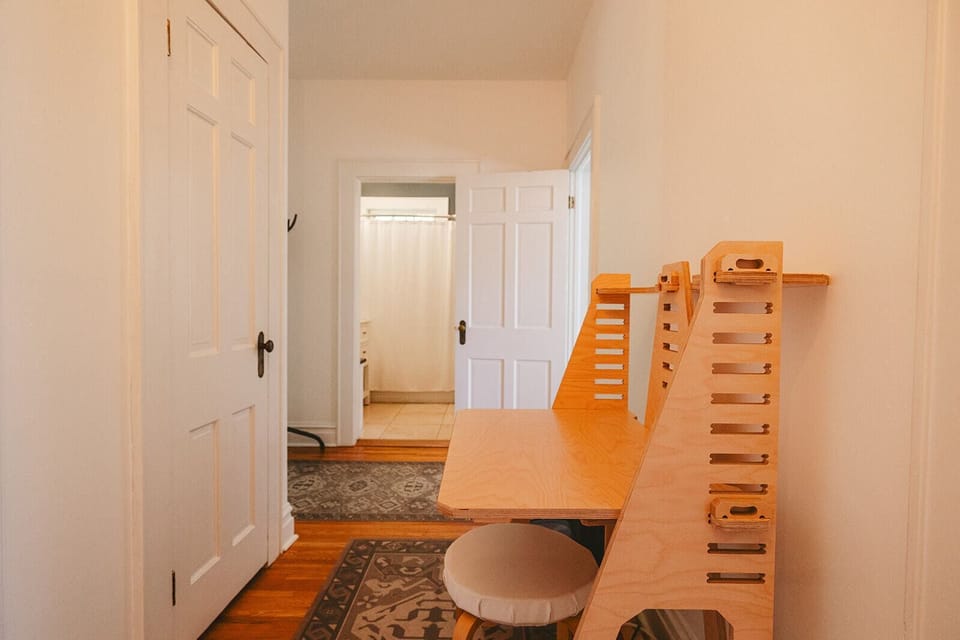 Adjustable small desk in the hallway in case you need to tackle some work. Looking into the bathroom