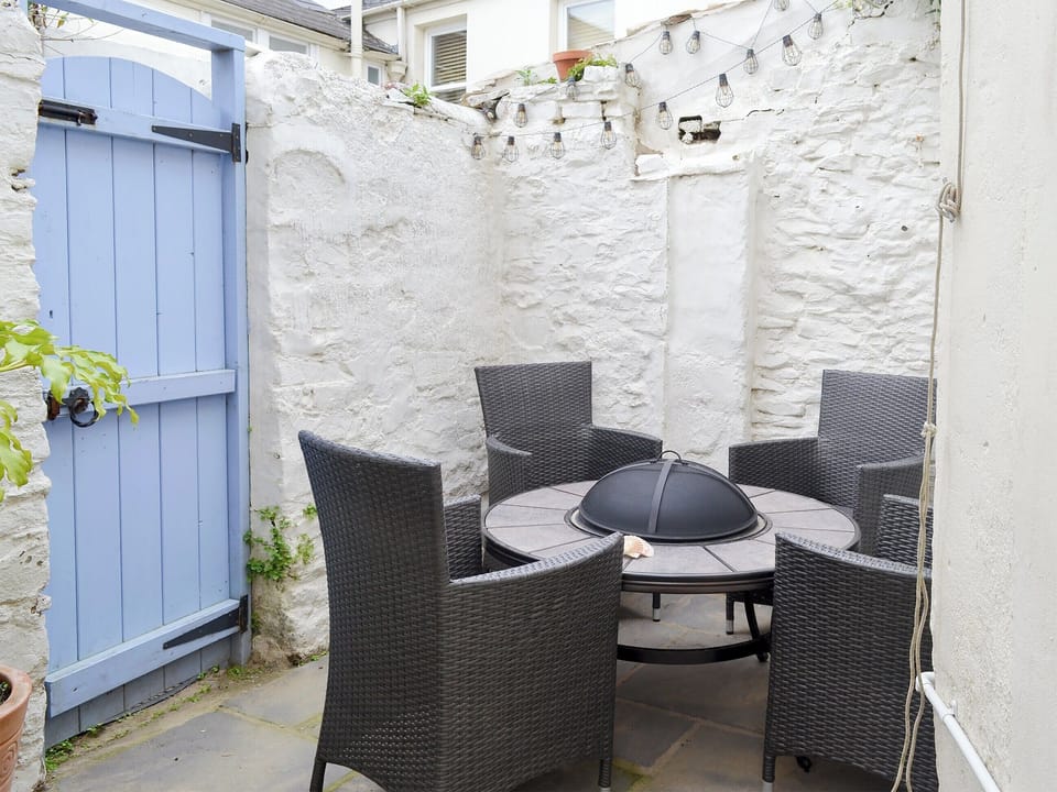 Enclosed courtyard with sitting-out area and firepit | Anchor Cottage, Instow, near Bideford