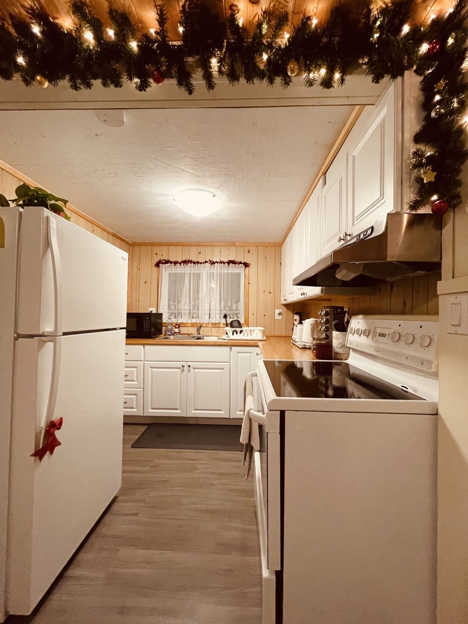 Kitchen with stove/oven, fridge, microwave and all other cooking amenities.