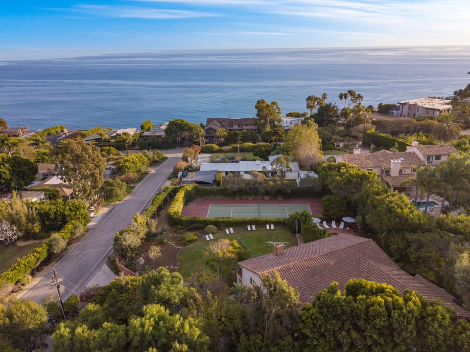 Steps to the beach with a private tennis court and beautiful views.